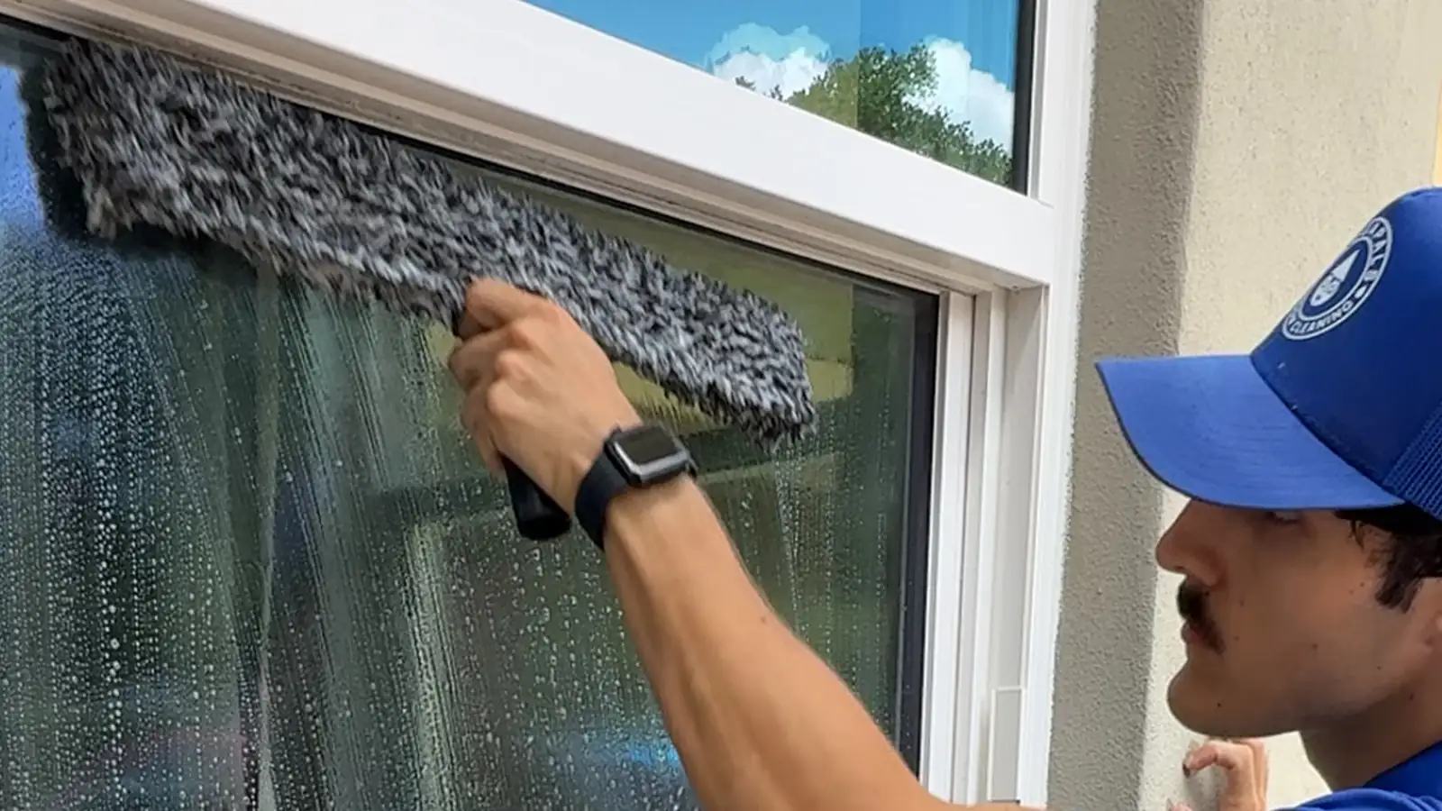 Aquapals technician cleaning an exterior window in Central Florida